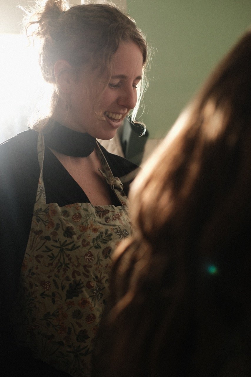 Flora smiling while cooking.